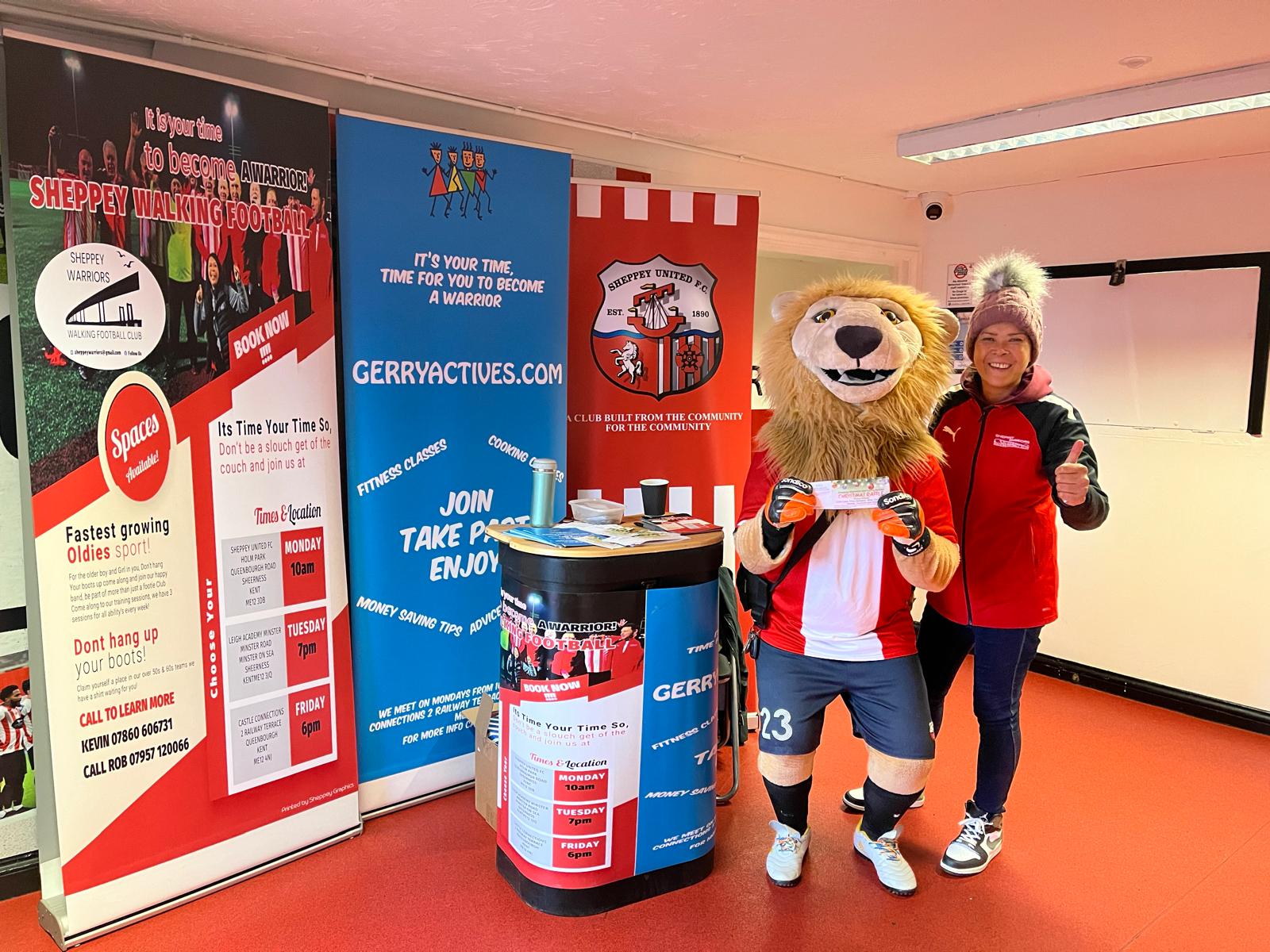 Club stand with banners, mascot and volunteer