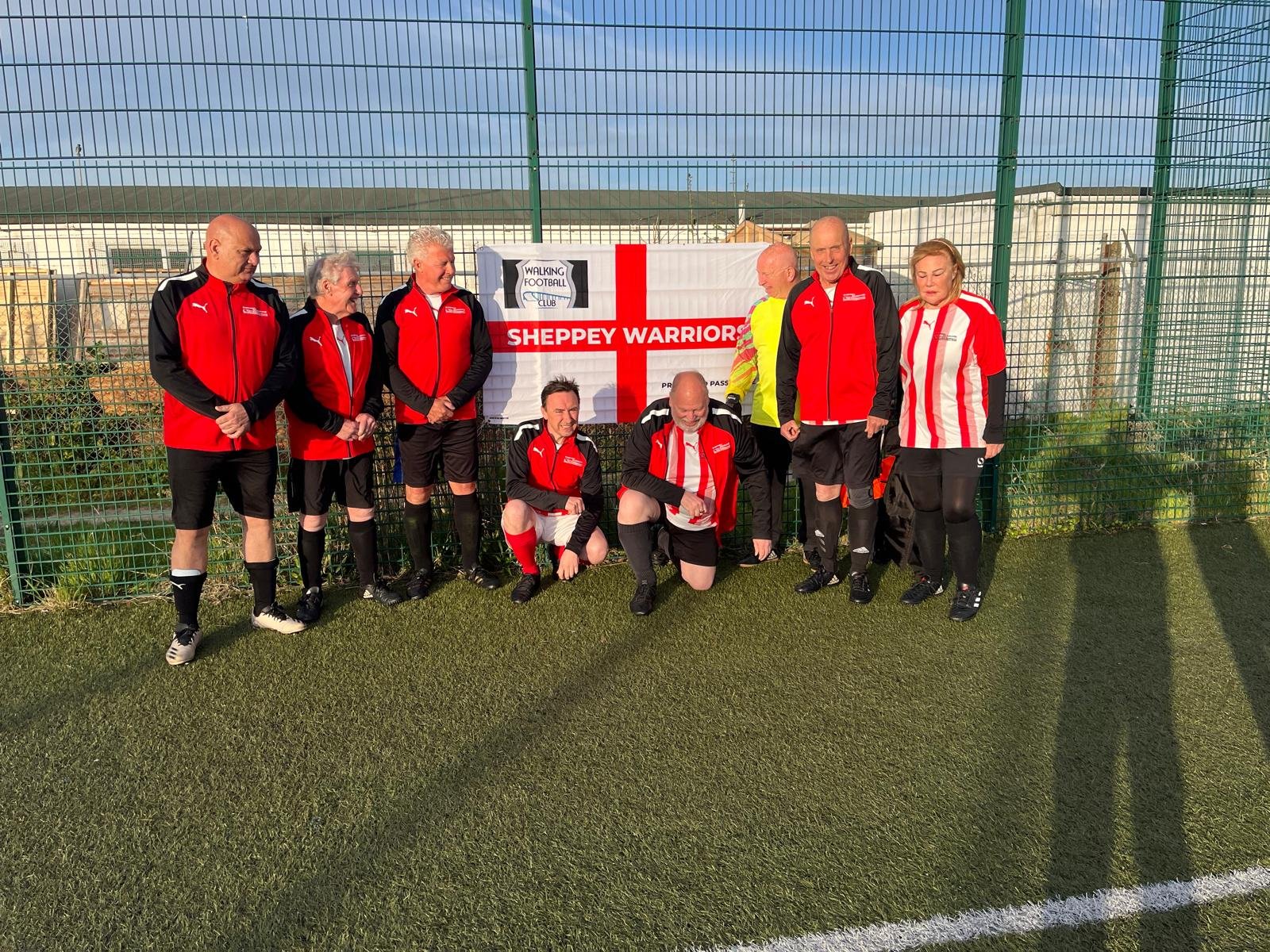 Sheppey Warriors with the club banner on the pitch